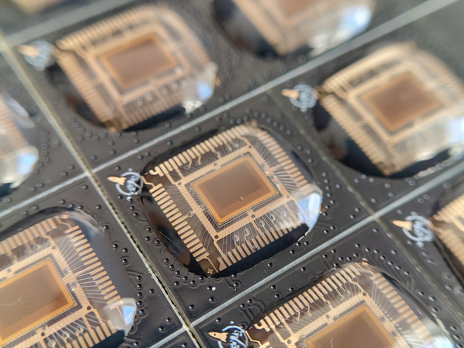 Wire-bonded chips on black circuit boards